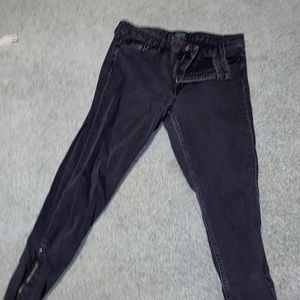 Black jeans with zippers at ankles